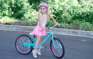 A girl riding her Guardian Aqua Pink Bike