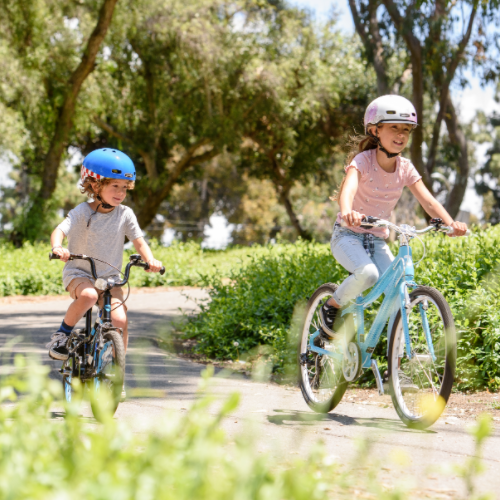 Two kids riding in the park